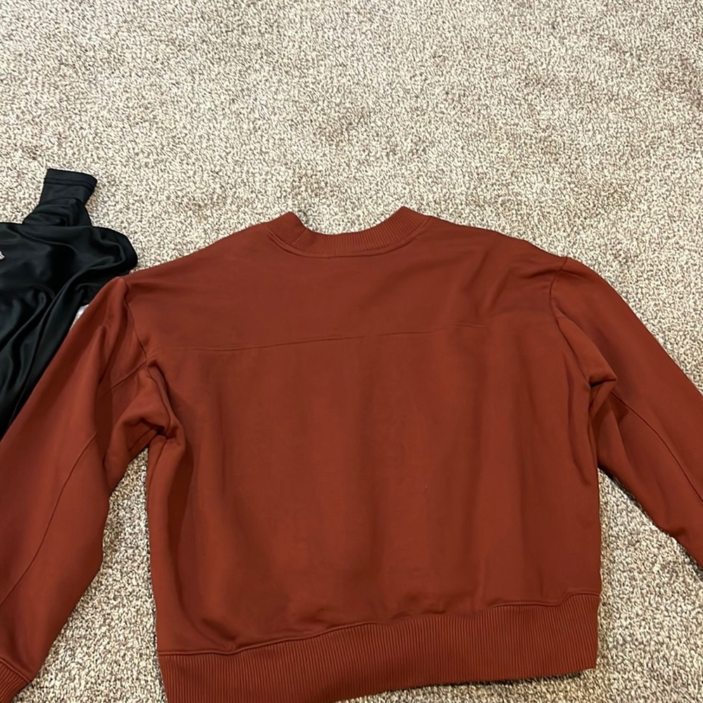 A new day, size large in a burnt orange crew neck